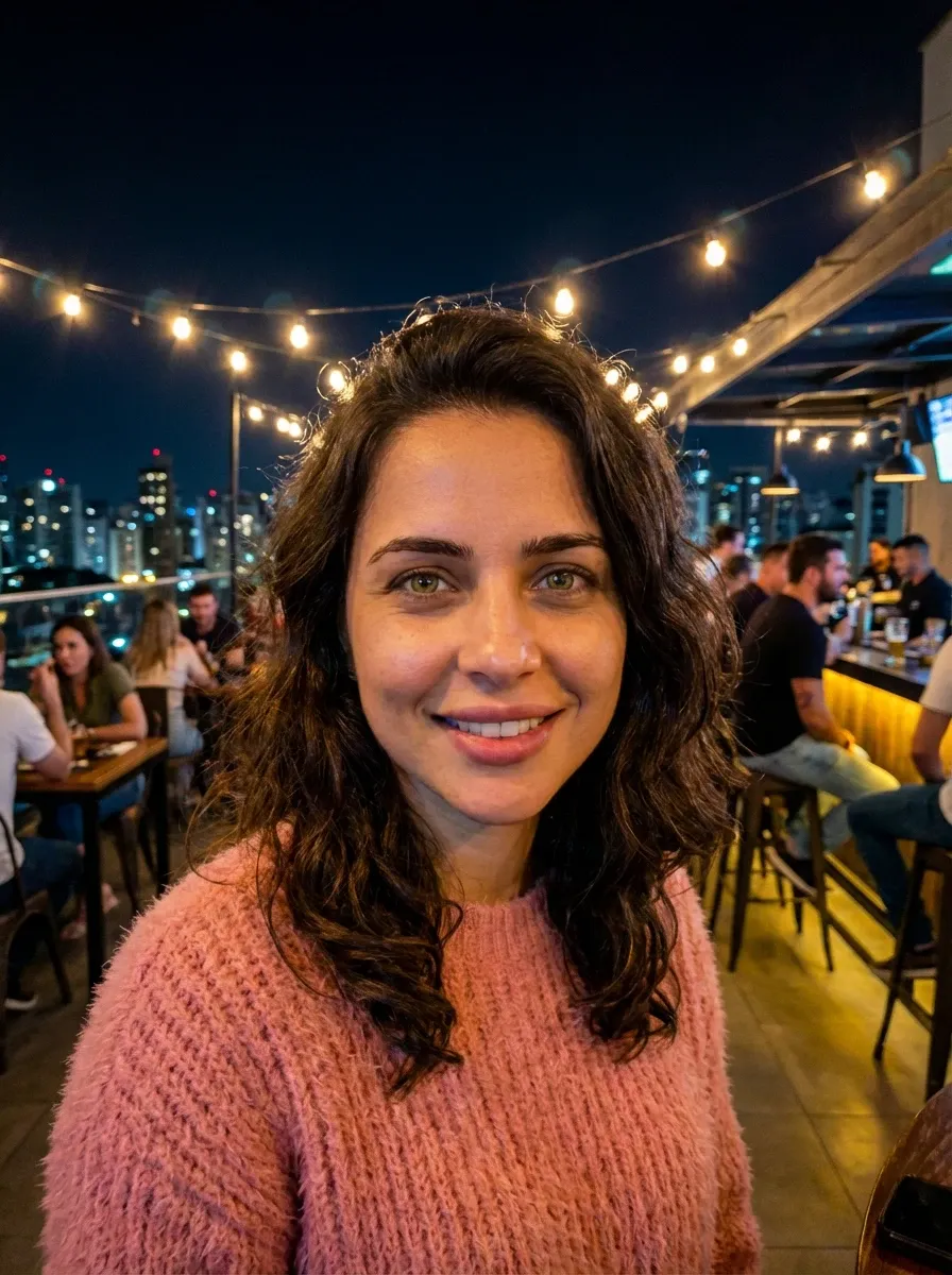 Original selfie input — woman in a pink sweater outdoors at night